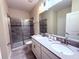Modern bathroom with double sinks and a walk-in shower at 1584 Sandbagger Dr, Davenport, FL 33896