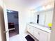Bathroom with double vanity and access to bedroom at 1584 Sandbagger Dr, Davenport, FL 33896