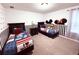Bedroom with twin beds, Mickey Mouse decor, and black and white striped walls at 1584 Sandbagger Dr, Davenport, FL 33896