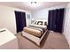 Bright bedroom with a queen bed and navy blue curtains at 1584 Sandbagger Dr, Davenport, FL 33896