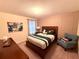 Cozy bedroom with a queen-size bed and sitting area at 1584 Sandbagger Dr, Davenport, FL 33896