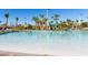 Relaxing community pool with a sandy beach entry and waterslide at 1584 Sandbagger Dr, Davenport, FL 33896