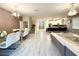 Open concept dining room with glass table and white chairs at 1584 Sandbagger Dr, Davenport, FL 33896
