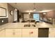 Modern kitchen with white cabinets, quartz countertops, and double sink at 1584 Sandbagger Dr, Davenport, FL 33896