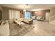 Spacious living room with white sectional sofa and large windows at 1584 Sandbagger Dr, Davenport, FL 33896