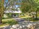 Charming light green house with mature trees and a brick walkway at 1601 Lyndale Blvd, Maitland, FL 32751