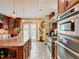 Open kitchen with granite island and stainless steel appliances at 1601 Lyndale Blvd, Maitland, FL 32751