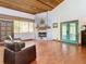 Living room featuring a cozy fireplace and hardwood floors at 1601 Lyndale Blvd, Maitland, FL 32751