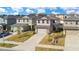 Aerial view of several two-story homes showcasing their well-maintained lawns, driveways, and neighborhood layout at 1778 Sundance Chase Rd, Minneola, FL 34715