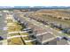 An aerial view of the neighborhood featuring rows of homes with fenced yards and landscaping at 1778 Sundance Chase Rd, Minneola, FL 34715