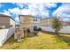 Large backyard with a white fence, featuring a swing set, slide, outdoor seating area, and green grass at 1778 Sundance Chase Rd, Minneola, FL 34715