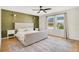 Bedroom with a paneled accent wall, ceiling fan, light-colored carpet, and two windows with coverings at 1778 Sundance Chase Rd, Minneola, FL 34715