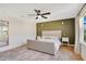 Bedroom with a paneled accent wall, ceiling fan, light-colored carpet, and two windows with coverings at 1778 Sundance Chase Rd, Minneola, FL 34715