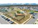 Aerial view of the community park, featuring playground equipment, dog park, shaded picnic areas, and parking at 1778 Sundance Chase Rd, Minneola, FL 34715