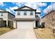 Two-story home with a two-car garage and a well-manicured lawn under a blue sky at 1778 Sundance Chase Rd, Minneola, FL 34715