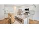 Modern kitchen with stainless steel appliances, granite countertops, and a large island at 1778 Sundance Chase Rd, Minneola, FL 34715