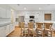 Bright kitchen featuring stainless steel appliances, granite countertops, and a breakfast bar at 1778 Sundance Chase Rd, Minneola, FL 34715