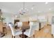 Open-concept living area with a fireplace, ceiling fan, and a connecting kitchen and dining area at 1778 Sundance Chase Rd, Minneola, FL 34715