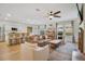 Open-concept living room with hardwood floors, modern furnishings, and ample natural light at 1778 Sundance Chase Rd, Minneola, FL 34715