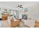 Bright and airy living room featuring a fireplace, ceiling fan, and hardwood floors at 1778 Sundance Chase Rd, Minneola, FL 34715