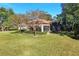 Landscaped backyard with lush lawn and partial home view at 1829 Brackenhurst Pl, Lake Mary, FL 32746