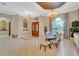 Spacious dining room with large table, chandelier, and hardwood floors at 1829 Brackenhurst Pl, Lake Mary, FL 32746