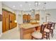Spacious kitchen with island, wood cabinets, and granite countertops at 1829 Brackenhurst Pl, Lake Mary, FL 32746