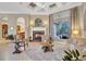 Living room features a fireplace, comfortable seating, and large windows at 1829 Brackenhurst Pl, Lake Mary, FL 32746