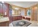 Spa-like Primary bathroom with double vanity, soaking tub, and walk-in shower at 1829 Brackenhurst Pl, Lake Mary, FL 32746