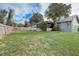 Wide backyard photo showcasing a grassy lawn and a screened porch at 1886 Elkcam Blvd, Deltona, FL 32725