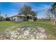View of backyard showing mature tree and screened in porch at 1886 Elkcam Blvd, Deltona, FL 32725