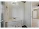 Bright bathroom with a vanity, decorative mirror, and a tiled floor at 1886 Elkcam Blvd, Deltona, FL 32725