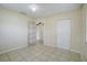 Neutral bedroom featuring tile floors, closet, and an en-suite door at 1886 Elkcam Blvd, Deltona, FL 32725