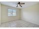 Well-lit bedroom features tile flooring and ceiling fan for comfortable living at 1886 Elkcam Blvd, Deltona, FL 32725