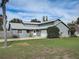 Charming single-story home with a well-manicured lawn and attached garage at 1886 Elkcam Blvd, Deltona, FL 32725