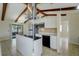 Bright kitchen with white cabinets, stainless steel appliances, island, and exposed wood beam vaulted ceilings at 1886 Elkcam Blvd, Deltona, FL 32725