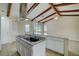 Open kitchen featuring white cabinets, stainless steel appliances, marble countertops, and views of the main living area at 1886 Elkcam Blvd, Deltona, FL 32725