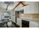 Modern kitchen with stainless steel appliances, an electric cooktop, and a stylish range hood at 1886 Elkcam Blvd, Deltona, FL 32725