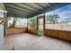 Enclosed patio featuring stone tile flooring and wood paneling, providing a comfortable outdoor space at 1886 Elkcam Blvd, Deltona, FL 32725