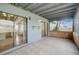 Covered patio with tile flooring, sliding glass doors, and a view of the backyard at 1886 Elkcam Blvd, Deltona, FL 32725