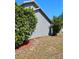 Home featuring new wood mulch, healthy foliage, and bright green exterior at 1886 Elkcam Blvd, Deltona, FL 32725