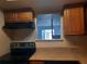 Compact kitchen area featuring a pass-through window to the living area and essential appliances at 1928 Conway Rd # 27, Orlando, FL 32812