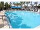 A refreshing outdoor swimming pool with clear blue water, lounge chairs, and shady cabana at 1928 Conway Rd # 27, Orlando, FL 32812
