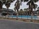 Beautiful community pool surrounded by palm trees and townhomes at 1928 Conway Rd # 27, Orlando, FL 32812