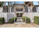 Inviting entrance with lush landscaping, a walkway leading to an elevated balcony area at 1928 Conway Rd # 40, Orlando, FL 32812