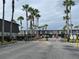 Gated community featuring lush landscaping and a secure entrance with palm trees at 1928 Conway Rd # 40, Orlando, FL 32812
