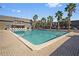 Community pool surrounded by mature palm trees and lounge chairs offering a relaxing resort style feel at 1928 Conway Rd # 40, Orlando, FL 32812