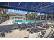 Inviting community pool with lounge chairs, a shaded area, and tables for residents to relax and socialize at 1928 Conway Rd # 40, Orlando, FL 32812