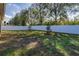 Large fenced backyard with grassy area and trees at 2147 Sunbow Ave, Apopka, FL 32703