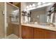 Bathroom with double sinks, granite countertop, and shower at 2147 Sunbow Ave, Apopka, FL 32703